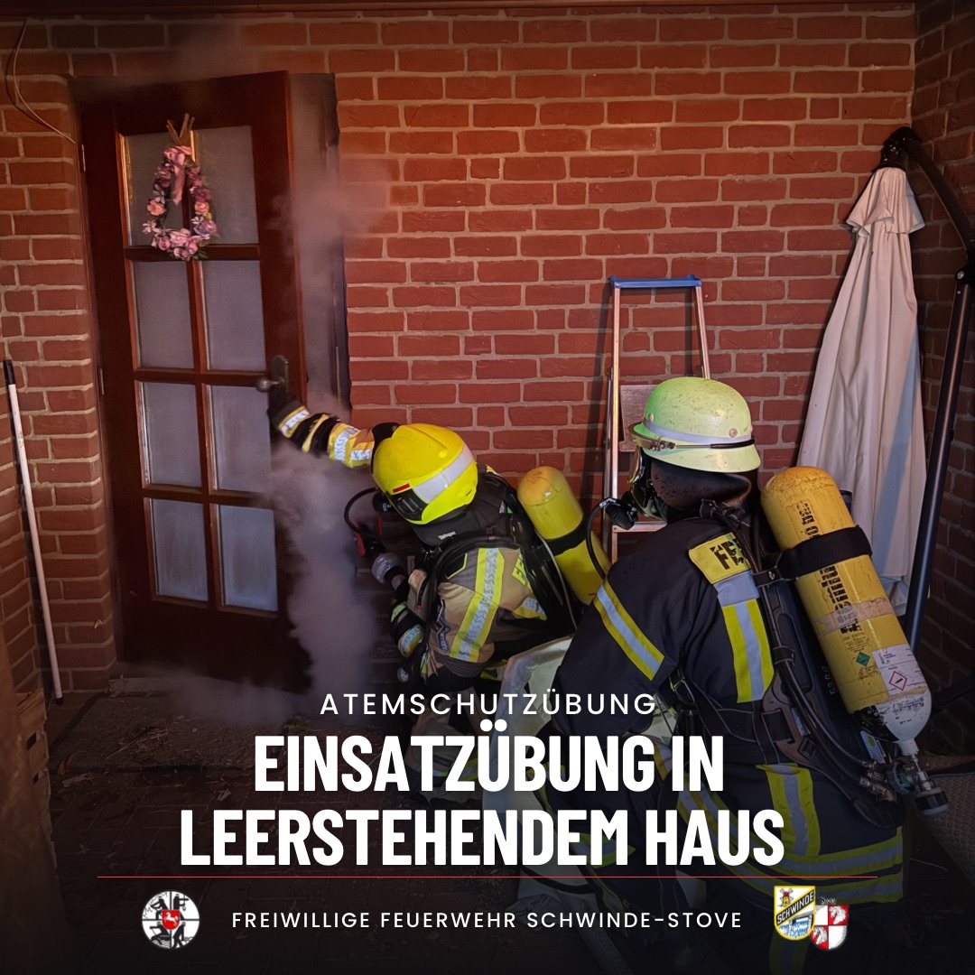 Zwei Atemschutzträger öffnen eine Tür bei einer Übung